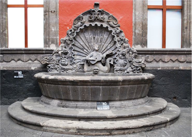 Picture Of Fountain Depicting A Mermaid Playing A Guitar
